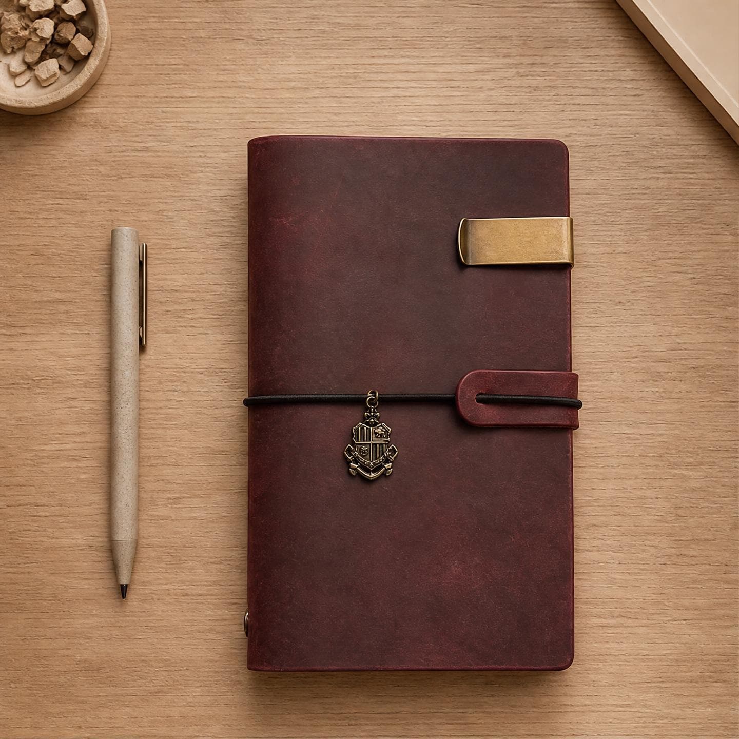 Deep red-brown chestnut crazy-horse leather travel journal with a brass crest charm