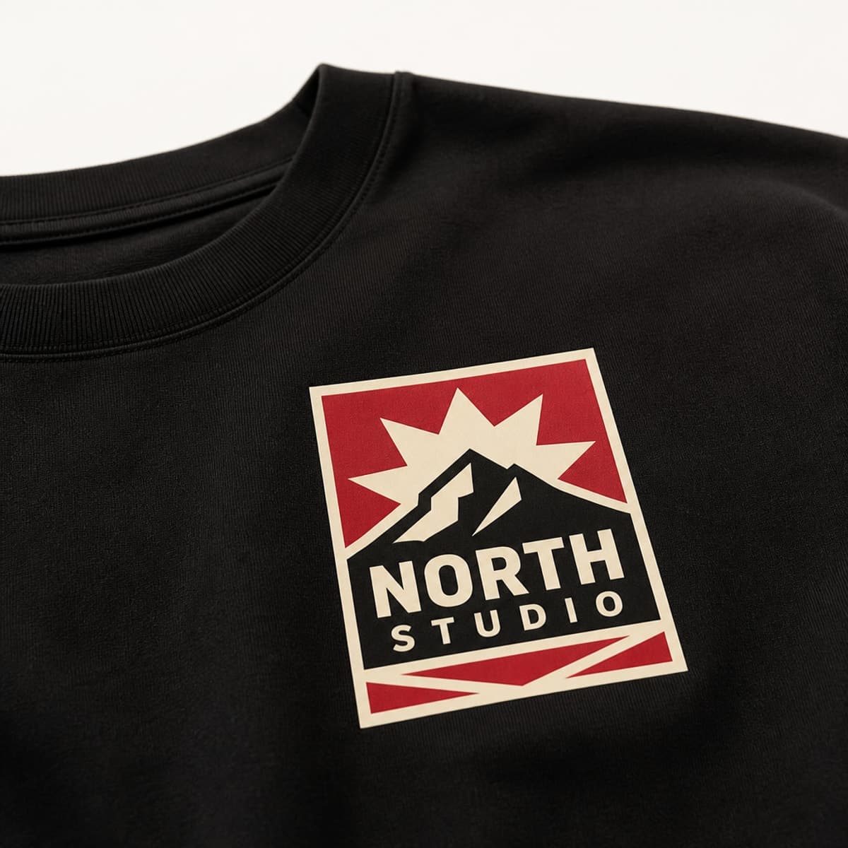 Black tee with North Studio multi-color heat transfer badge