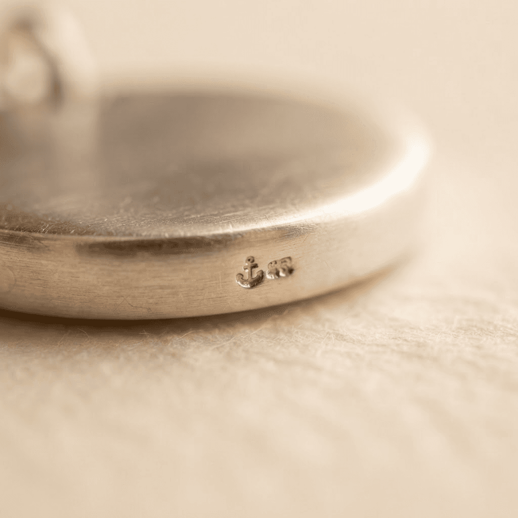 Macro of the silver hallmark stamped on the pendant edge